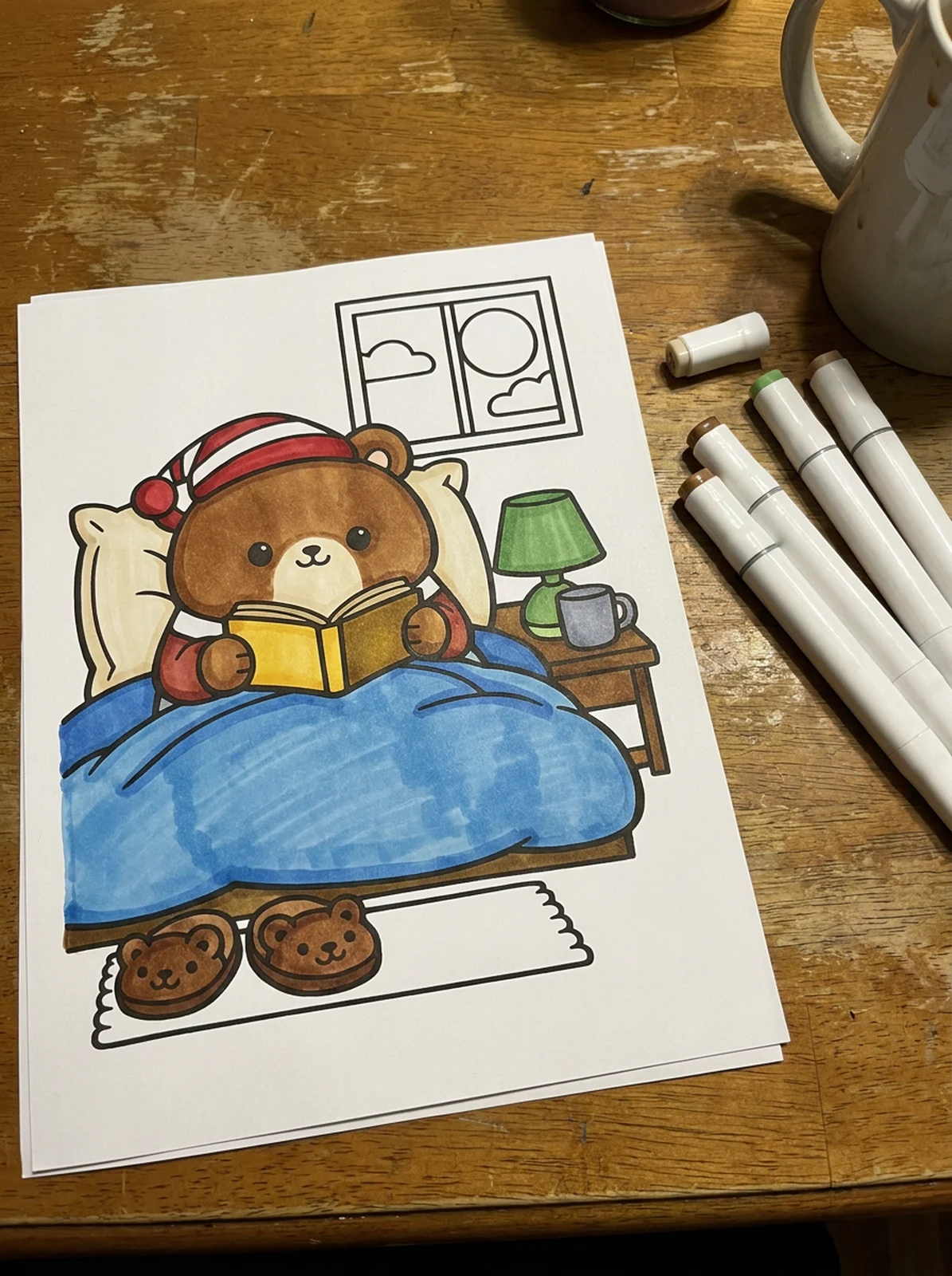 Bear Reading in Bed coloring page printed and half colored with markers