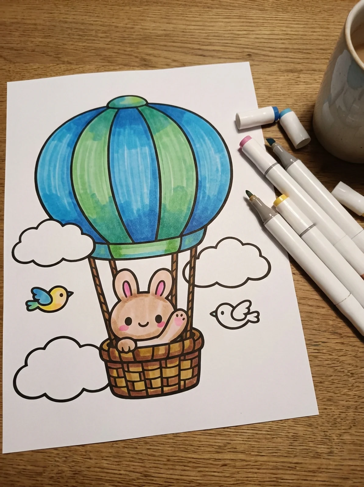Bunny in a Hot Air Balloon coloring page printed and half colored with markers