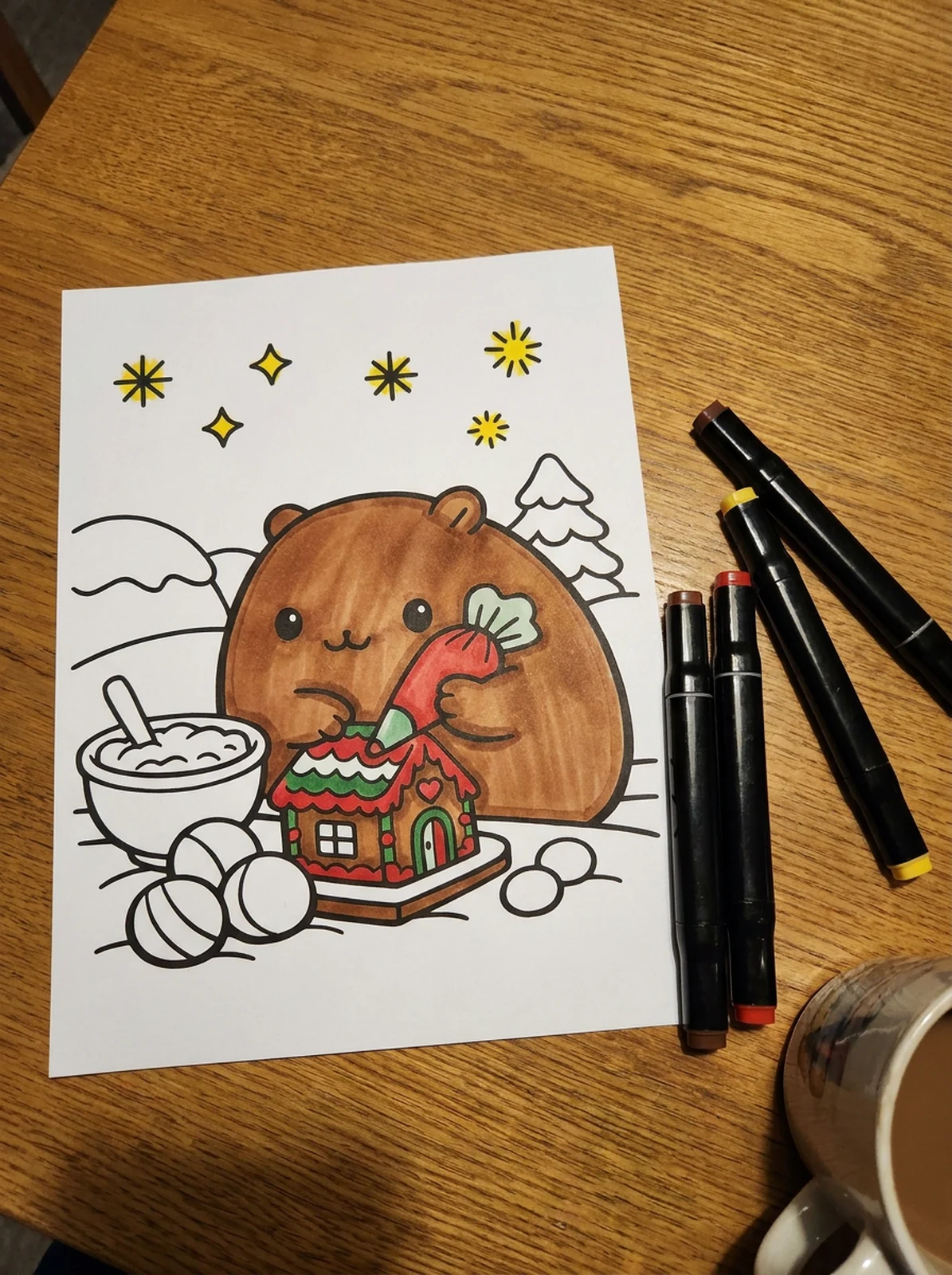 Capybara Building a Gingerbread House coloring page printed and half colored with markers