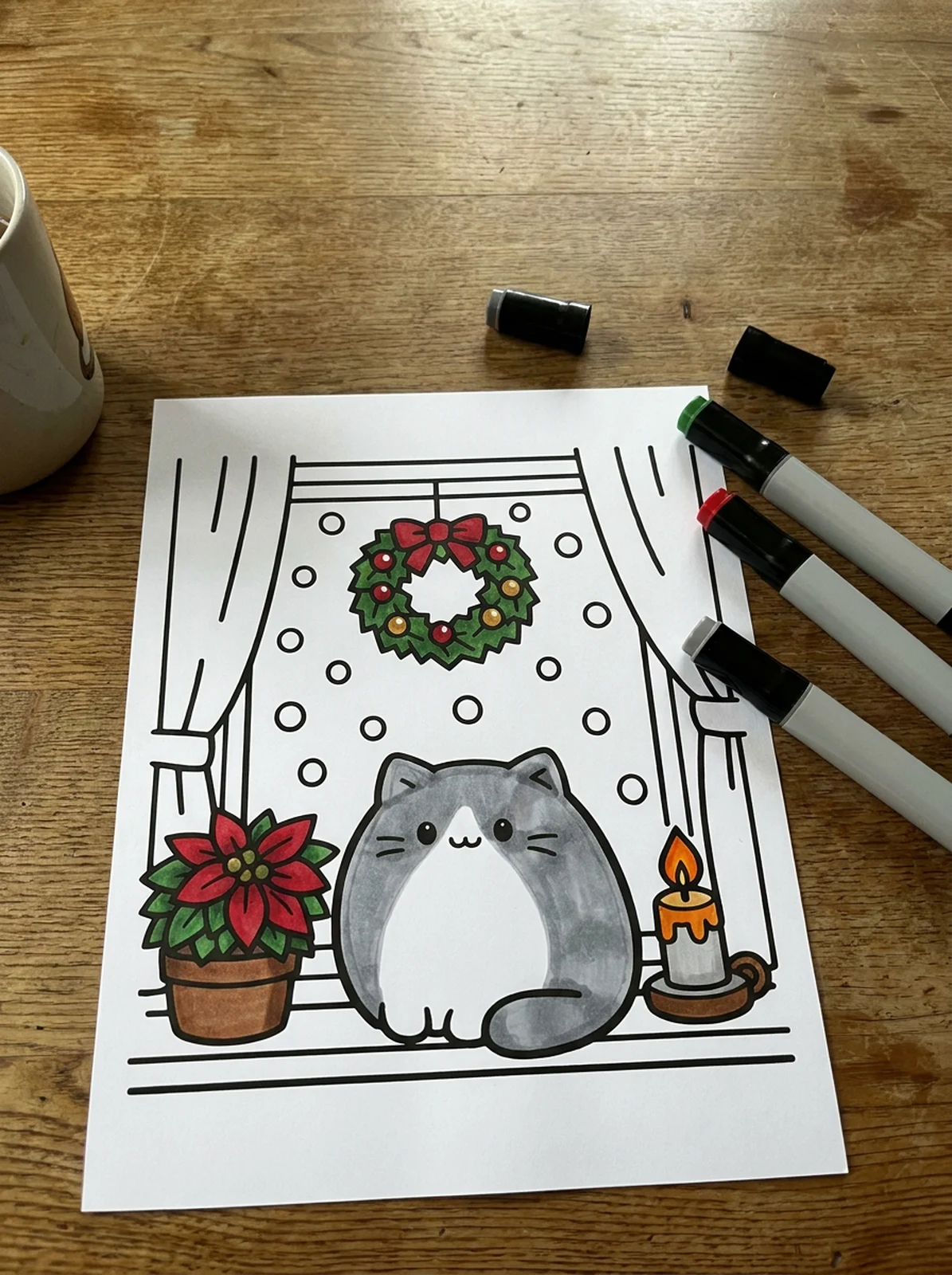 Cat in a Christmas Window coloring page printed and half colored with markers