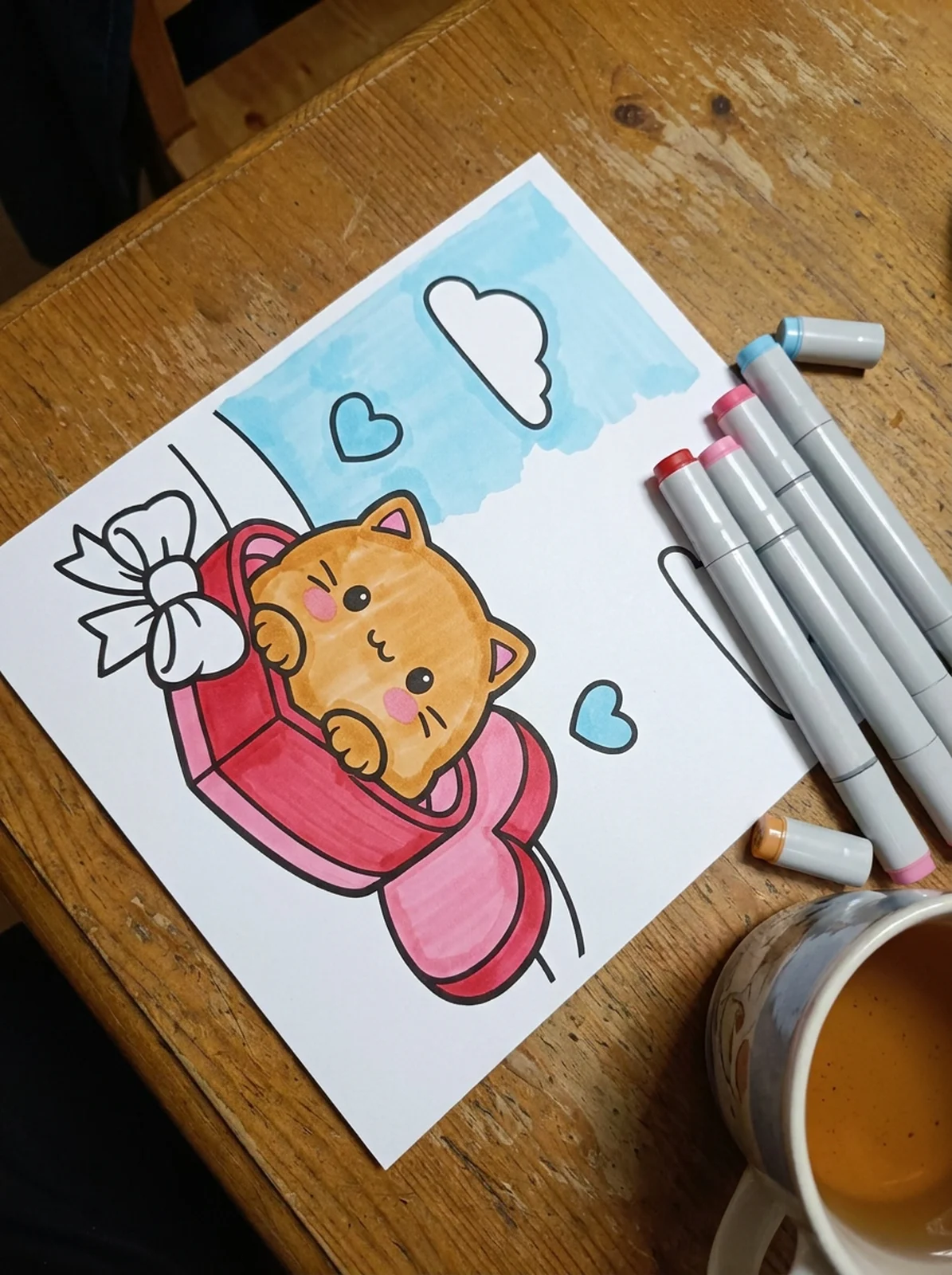 Cat in a Heart-Shaped Box coloring page printed and half colored with markers