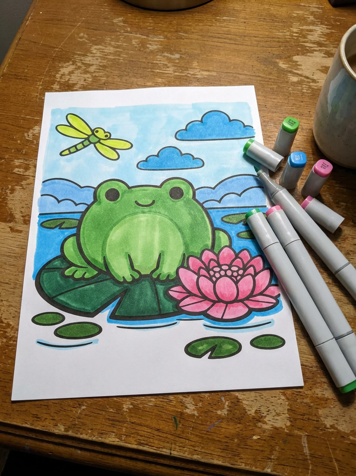 Frog Sitting on a Lily Pad coloring page printed and half colored with markers