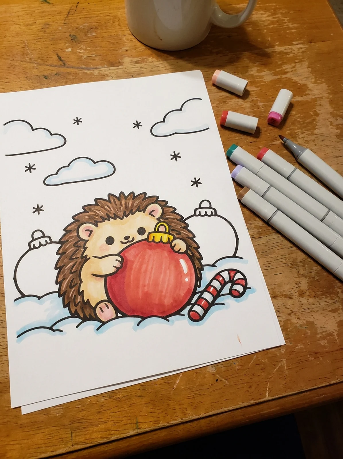Hedgehog Hugging a Christmas Ornament coloring page printed and half colored with markers