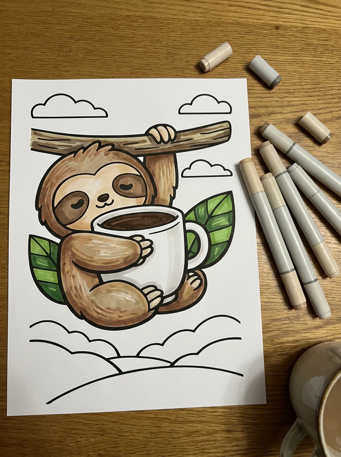 Sloth Hugging a Coffee Cup coloring page printed and half colored with markers
