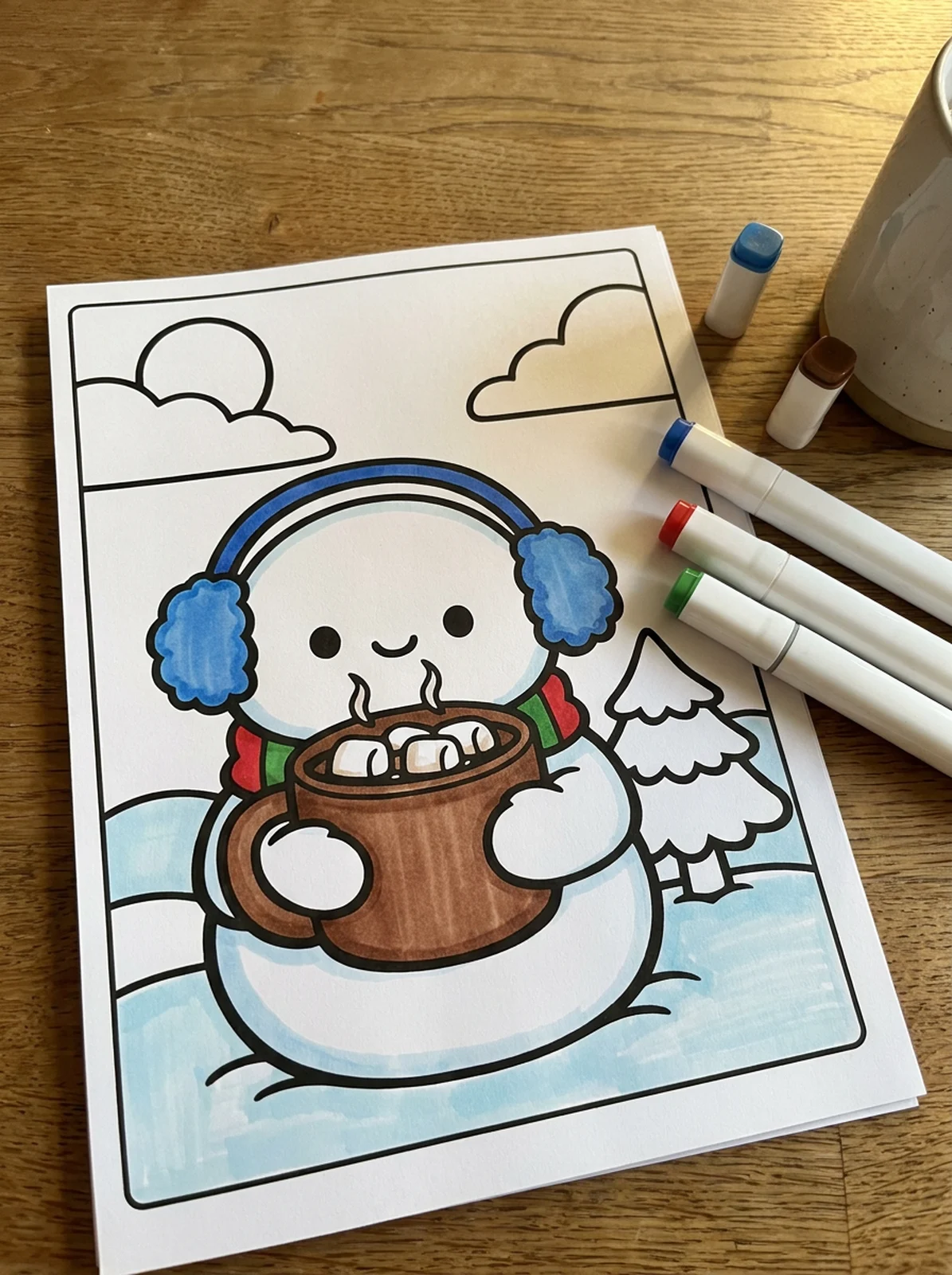 Snowman Holding Hot Cocoa coloring page printed and half colored with markers